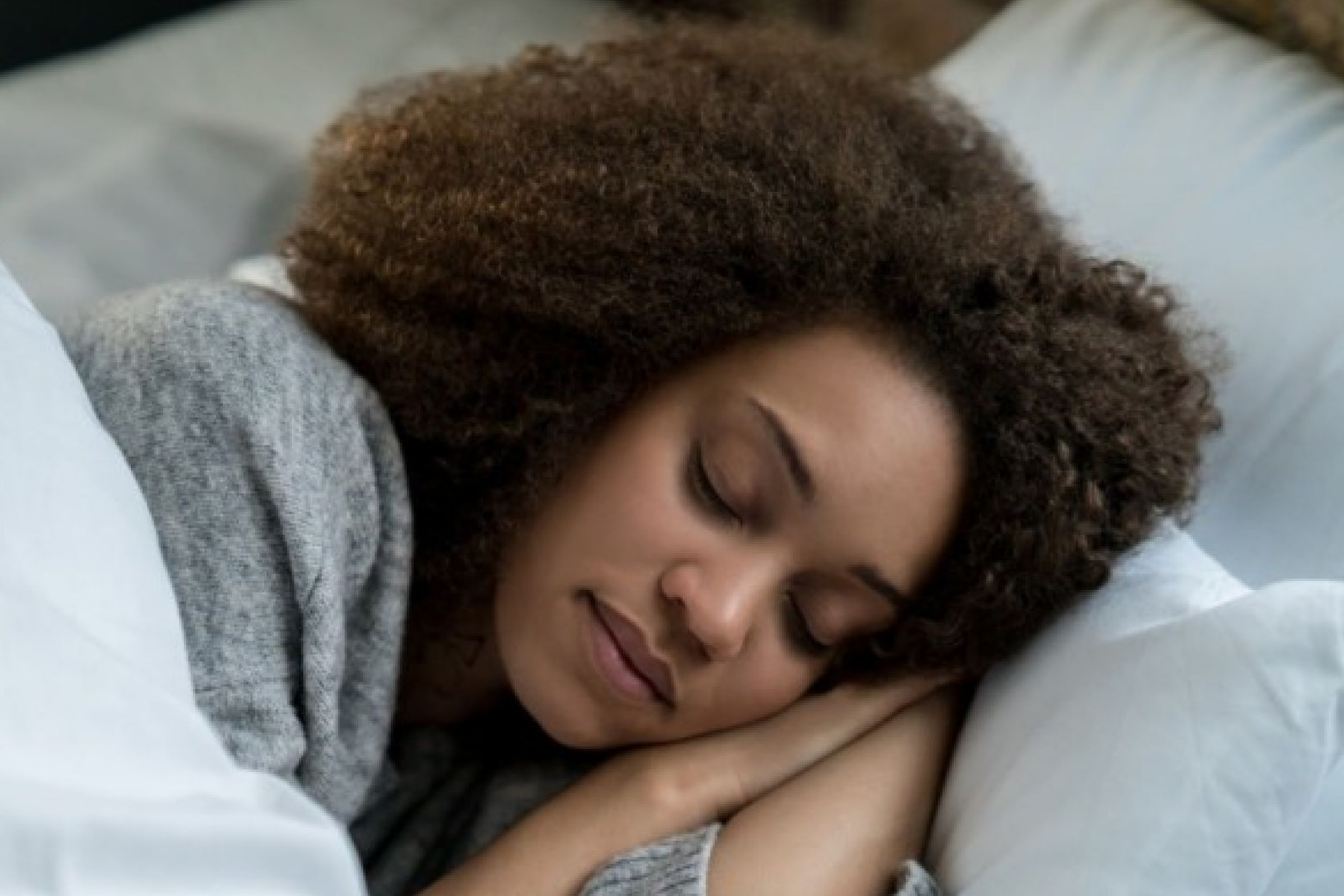 image of black woman, afro sleeping soundly